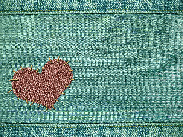 istock Background - heart attached by threads to jeans 92400315