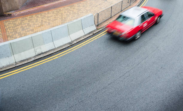 istock red cabs driving on city street 924011942