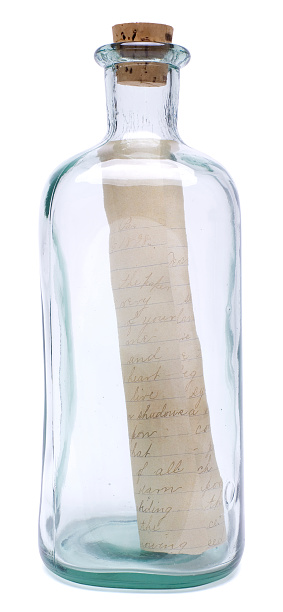 A vintage bottle with a cork, which contains an old letter. Isolated on white. Clipping path included.