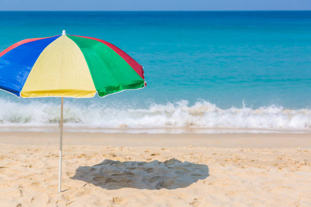 Beach umbrella on the beach sunny day, sea in background.