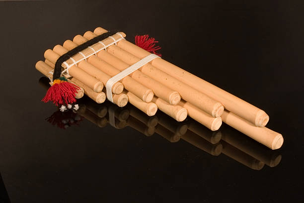 Andean Pan Pipes on Reflective Black Background stock photo