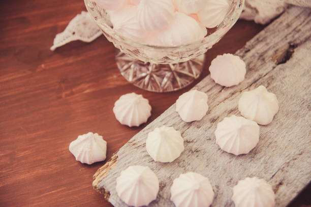 istock Meringues in a cup on the wooden table, top view 924026648