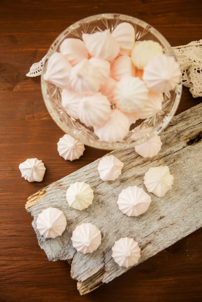istock Meringues in a cup on the wooden table, top view 924026652