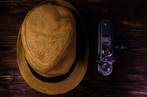istock Old rangefinder camera and hat on a wooden table 924027556