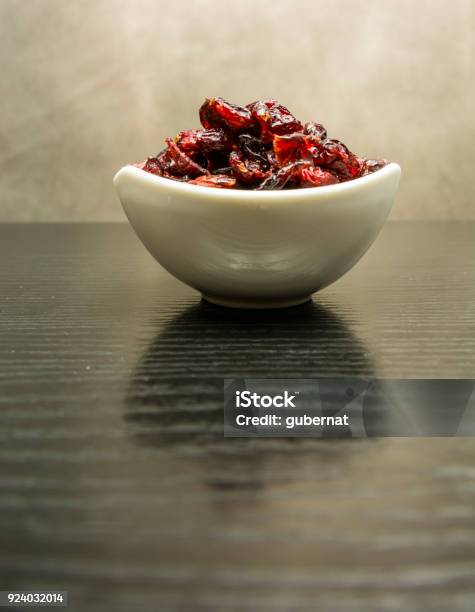 Dried Cranberries In A White Porcelain Bowl Stock Photo - Download Image Now - Backgrounds, Bearberry, Berry