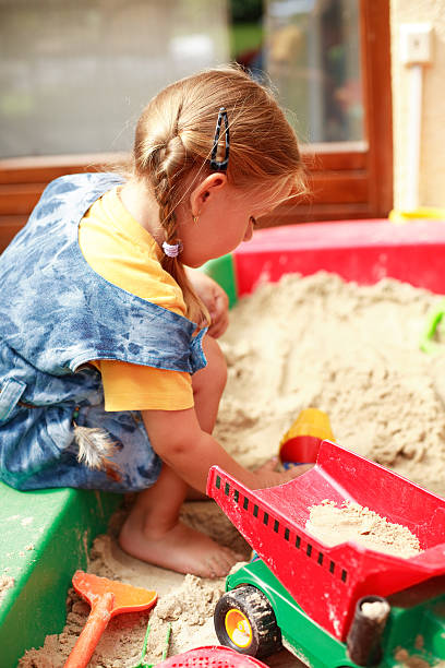 istock Girl playing in sand 92403951