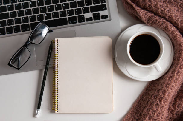 istock Notepad, laptop and coffee cup on wood table 924045222