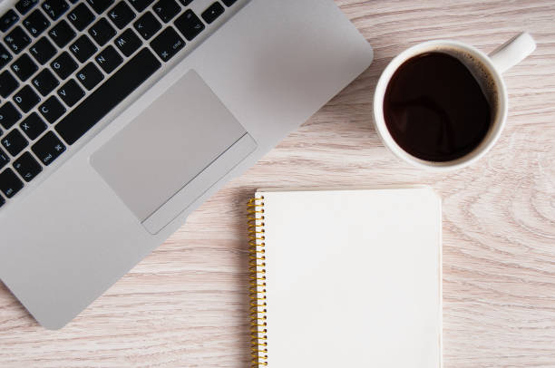 istock Notepad, laptop and coffee cup on wood table 924045576