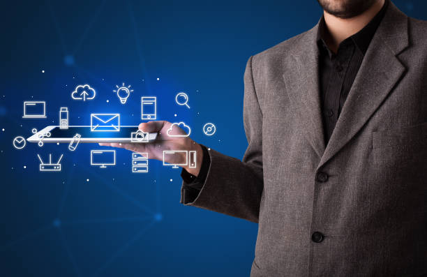istock Businessman holding tablet with media graphics 924045822