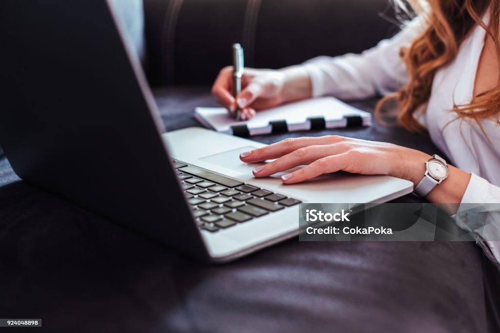Woman using laptop Woman using laptop at home Adult Stock Photo