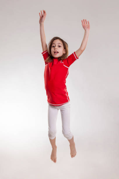 istock Little girl jumping isolated on white background 924049100