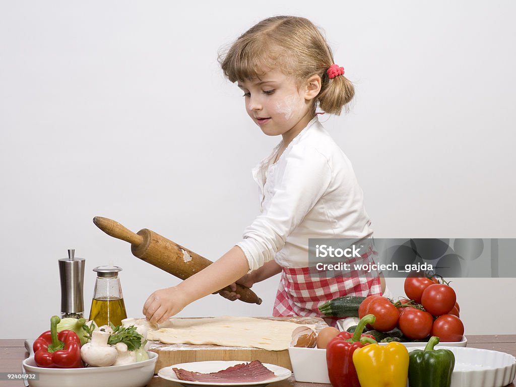 Cute girl making pizza  Apron Stock Photo