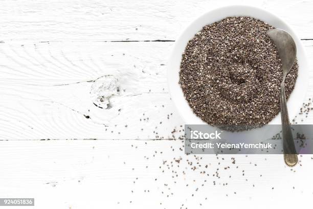 Chia Seeds In Bowl On White Wooden Background Top View Stock Photo - Download Image Now