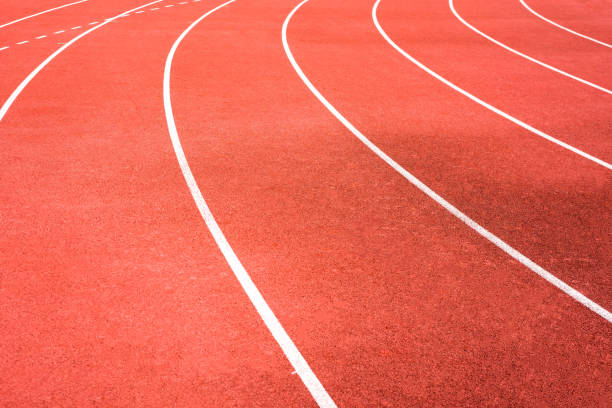 istock red running track on athletic stadium background texture 924052040