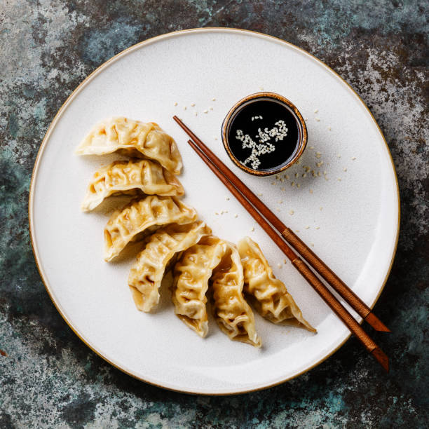 istock Gyoza dumplings on plate, chopsticks and soy sauce 924052620
