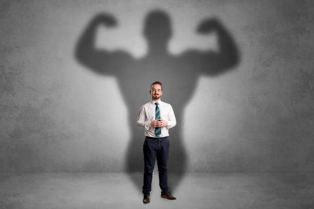istock Businessman with muscular shade behind his back 924058680