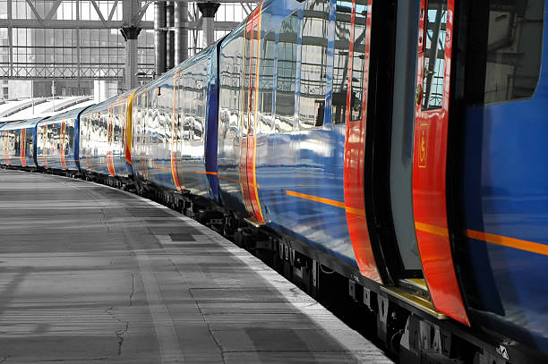 Train pulled up in station with open doors Color desaturation abstract of commuter train on an empty station platform. commuter train photos stock pictures, royalty-free photos & images