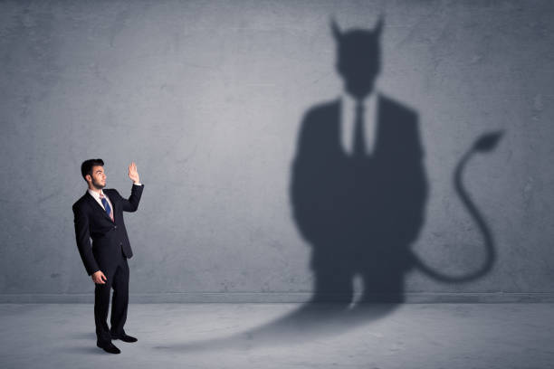 istock Business man looking at his own devil demon shadow concept 924059068