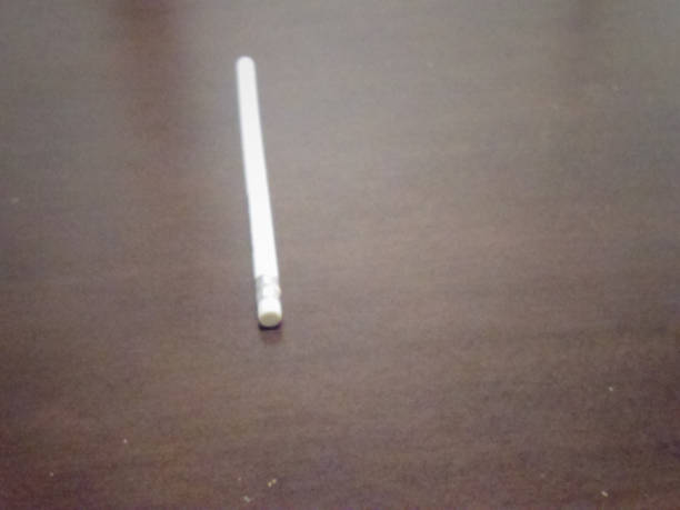 Side view of a number 2 pencil stub, macro photo on isolated white background.