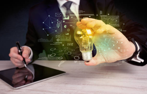 istock businessman holding glowing glass light bulb 924065476