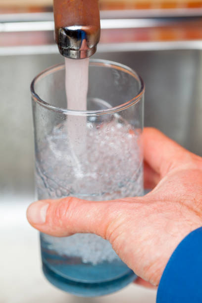 istock Filling up a glass with raw water from kitchen faucet 924068214