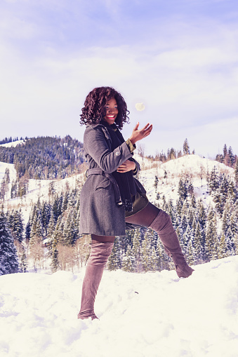 Fashionable winter clothing for women of great size and good mood with snowball