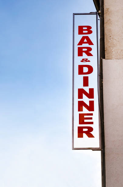 istock Neon lit BAR DINNER sign in daylight 924070244