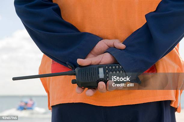 A Coast Guard On Duty Holding A Walkietalkie Stock Photo - Download Image Now - Walkie-talkie, Customs Official, Security