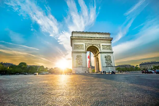 Paris Arc de Triomphe (Triumphal Arch) in Chaps Elysees at sunset, Paris, France. Architecture and landmarks of Paris. Postcard of Paris
