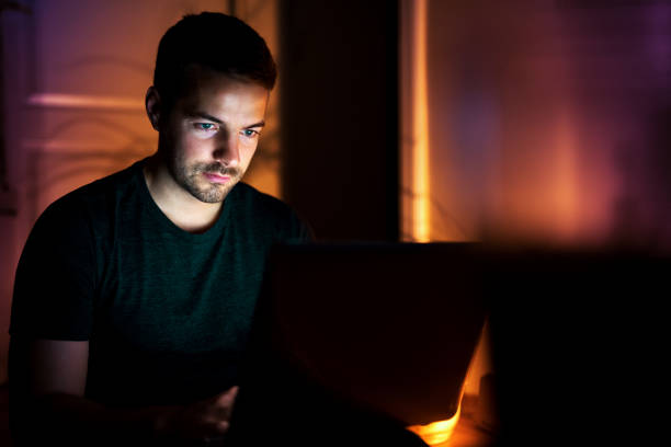 istock Nice man chatting with friends sitting on floor with laptop 924073040