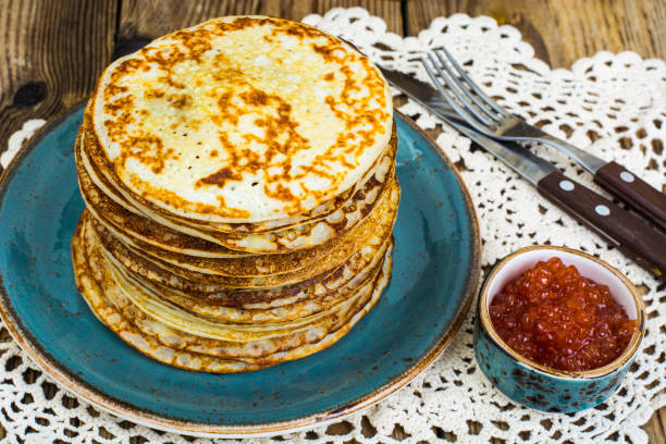 Fresh delicious pancakes with red caviar. Studio Photo