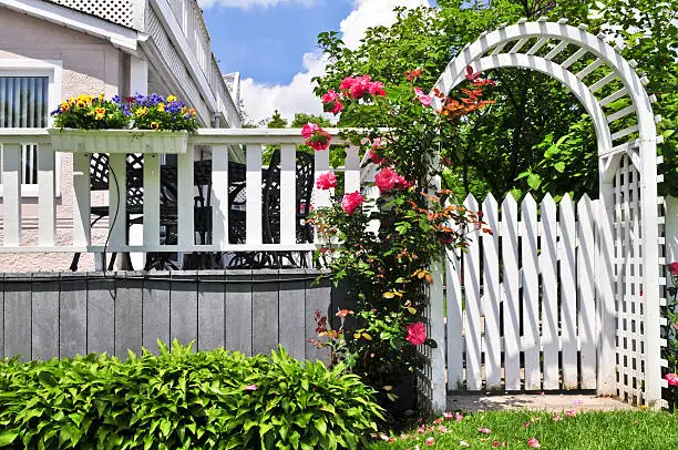 Photo of White arbor in a garden