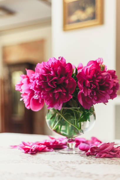 istock red peonies in glass vase stand on table 924080190