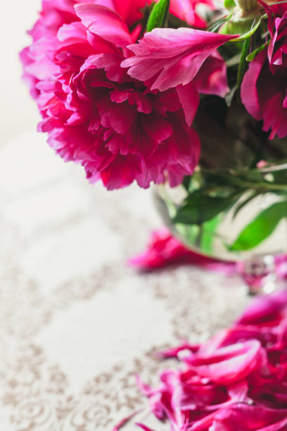 istock red peonies in glass vase stand on table 924080284