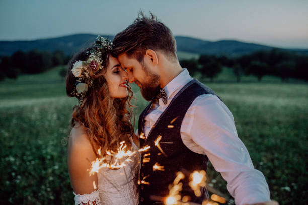 istock Beautiful bride and groom with sparklers on a meadow. 924080906