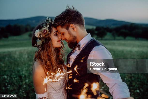 Beautiful Bride And Groom With Sparklers On A Meadow Stock Photo - Download Image Now