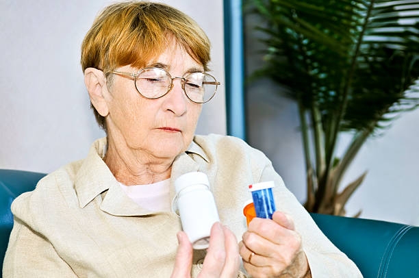 istock Elderly woman reading pill bottles 92408268