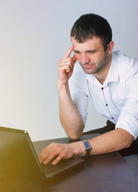 istock Successful man working on laptop. Confident businessman. White background 924087254