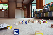 Kids house with toys on carpet.