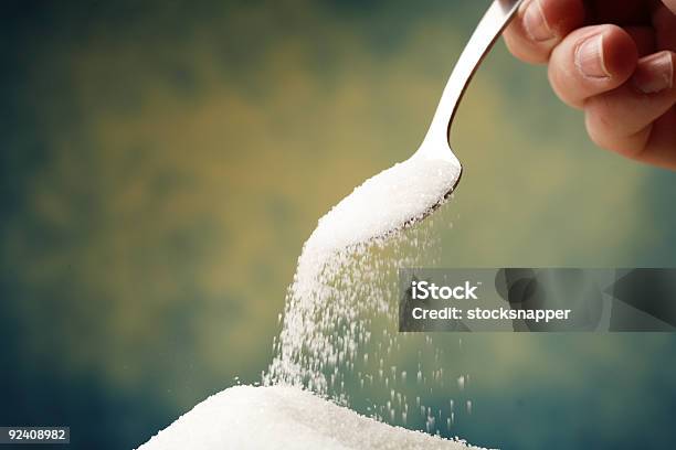 Spoon Dumping Sugar Into A Pile Stock Photo - Download Image Now - Sugar - Food, Pouring, Plus Sign