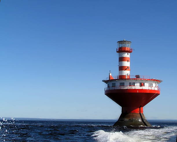 istock Red-and-white lighthouse in the middle of sea 92409081