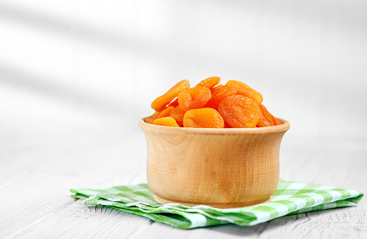 Delicious dried apricots in the bowl. The concept is healthy food, vegetarianism, diet, vitamins.