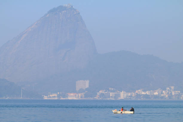 Fishermen rowing their boat in Guanabara Bay, Rio de Janeiro