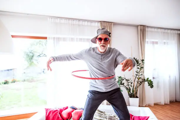 Photo of Senior man having fun at home.