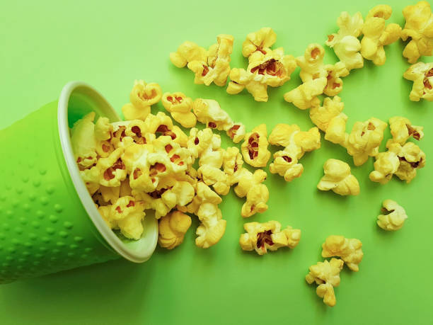istock popcorn in a glass on a green background 924101320