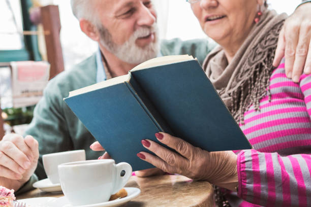 istock Senior reading book together during coffee 924103728