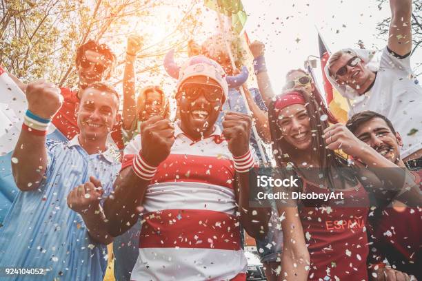 Multinational Football Supporters Celebrating The Begin Of World Competition Happy Multiracial People Having Fun Together Outside Of Stadium Main Focus On Black Man Sport And Bonding Concept Stock Photo - Download Image Now