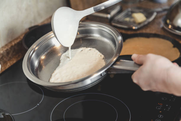 istock liquid dough is poured onto frying pan 924104868