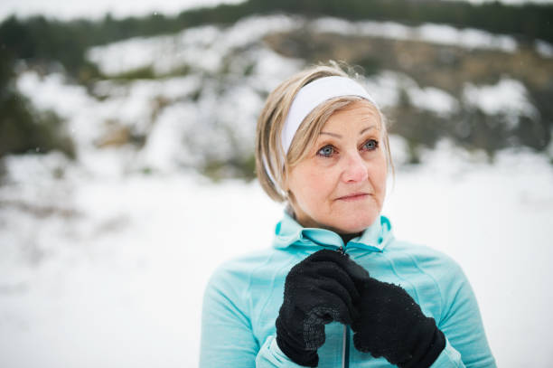 istock Senior woman jogging in winter nature. 924105342