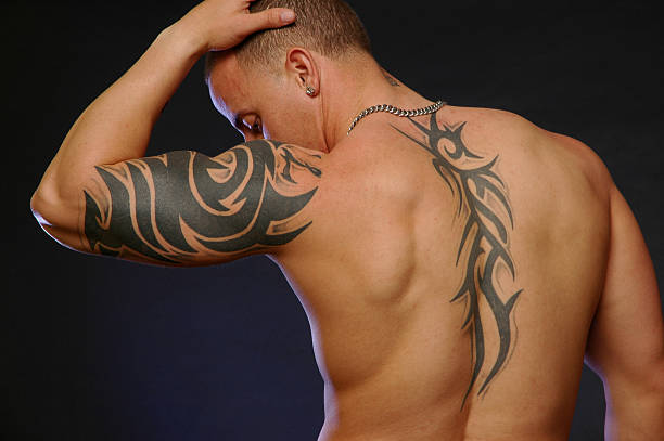 istock male with tribal tattoo's 92410768